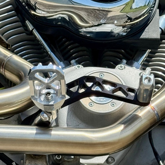 The TC Bros. Pro Series Truss Brake Pedal fits 1991-2017 Harley-Davidson Dyna models, featuring a billet aluminum construction with cut-out triangular patterns and mounting holes.