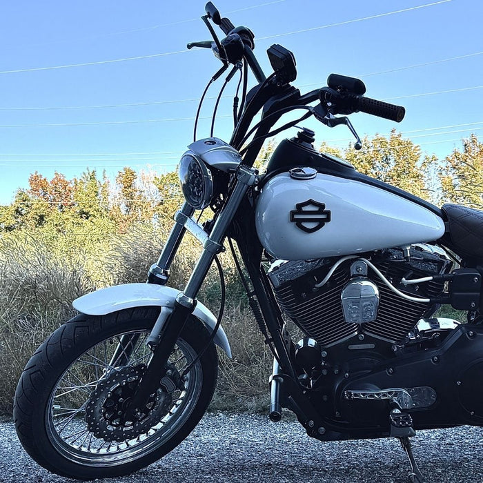 Two billet aluminum TC Bros. Pro Series Truss Shift Levers for 1991-2017 Harley-Davidson Dyna, one black and one silver, with cutout geometric patterns, are displayed on a white background—perfect for your next CNC machined upgrade.