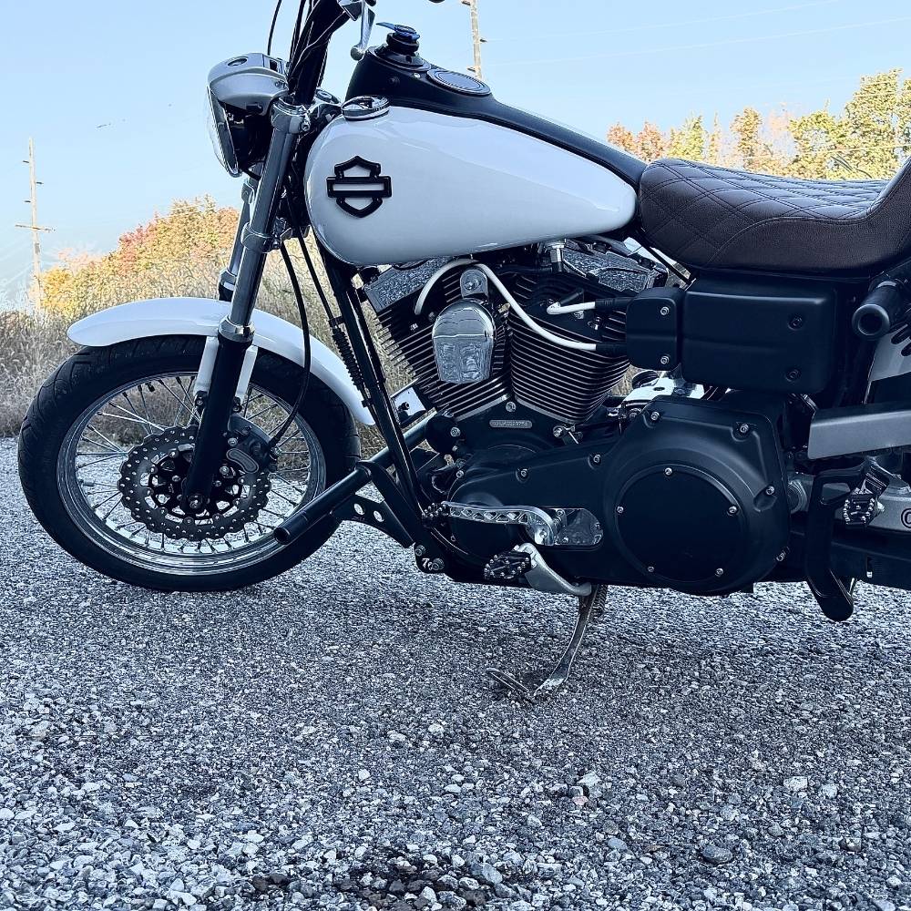 Two billet aluminum TC Bros. Pro Series Truss Shift Levers for 1991-2017 Harley-Davidson Dyna, one black and one silver, with cutout geometric patterns, are displayed on a white background—perfect for your next CNC machined upgrade.