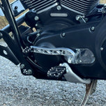 Two billet aluminum TC Bros. Pro Series Truss Shift Levers for 1991-2017 Harley-Davidson Dyna, one black and one silver, with cutout geometric patterns, are displayed on a white background—perfect for your next CNC machined upgrade.