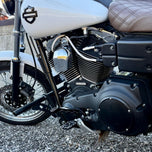 Two billet aluminum TC Bros. Pro Series Truss Shift Levers for 1991-2017 Harley-Davidson Dyna, one black and one silver, with cutout geometric patterns, are displayed on a white background—perfect for your next CNC machined upgrade.