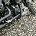 The TC Bros. Pro Series Truss Brake Arm is a 6061-T6 aluminum upgrade for 2018-up Harley-Davidson Softail brake pedals, featuring triangular cutouts and a circular mounting hole—available in silver or black.