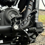 The TC Bros. Pro Series Truss Brake Arm is a 6061-T6 aluminum upgrade for 2018-up Harley-Davidson Softail brake pedals, featuring triangular cutouts and a circular mounting hole—available in silver or black.