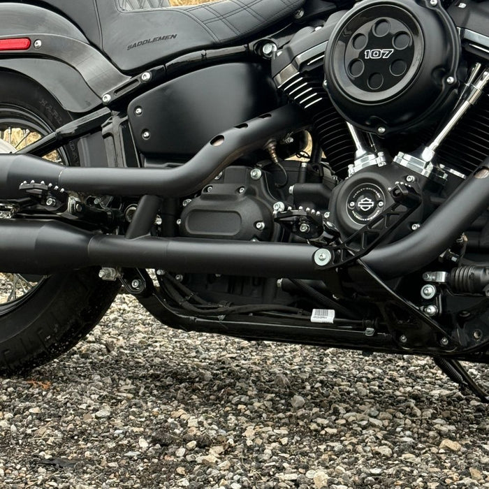 The TC Bros. Pro Series Truss Brake Arm is a 6061-T6 aluminum upgrade for 2018-up Harley-Davidson Softail brake pedals, featuring triangular cutouts and a circular mounting hole—available in silver or black.