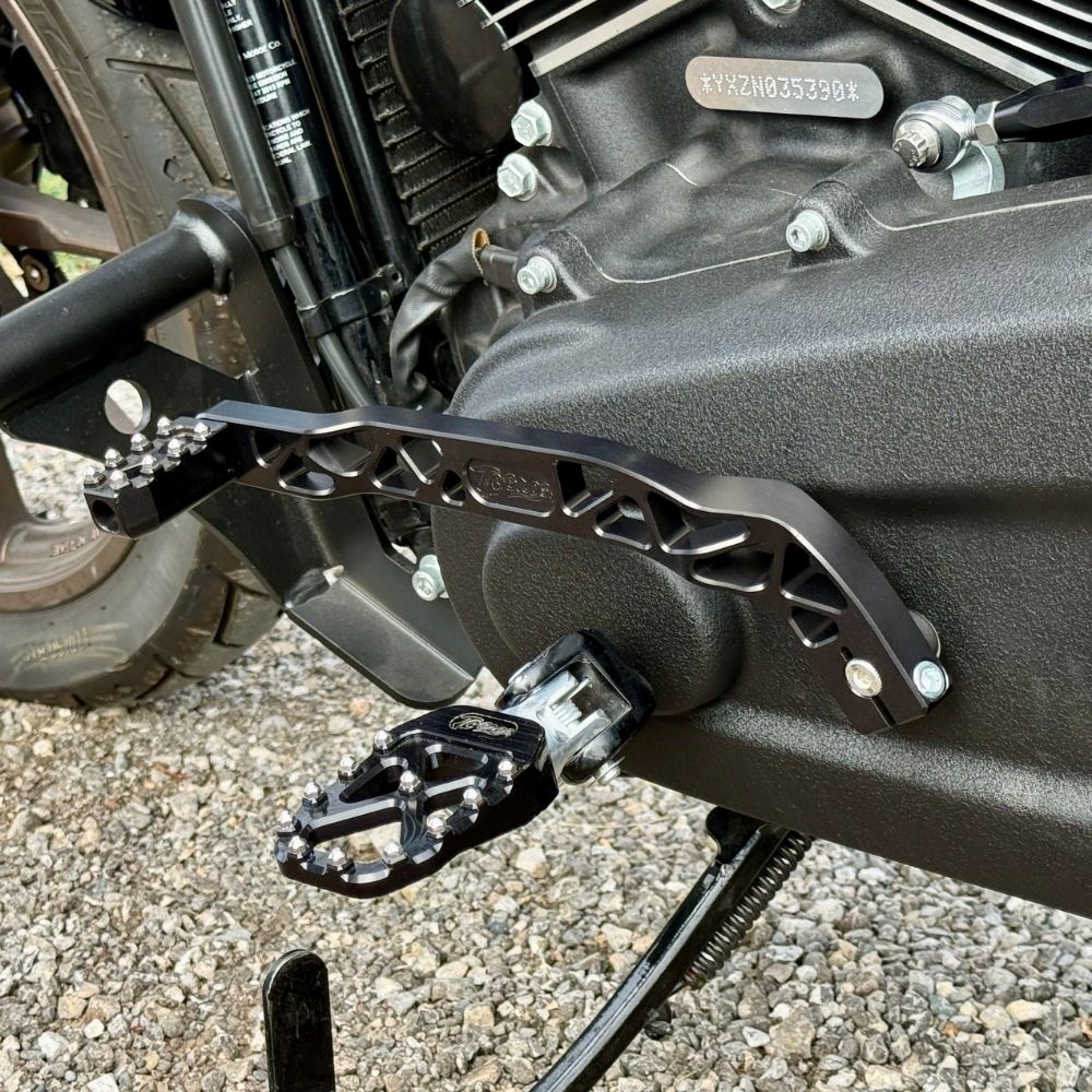 The TC Bros. Pro Series Truss Shift Lever for 2018-Up Harley-Davidson M8 Softail features silver and black metal lever arms with geometric cut-outs and "TC Bros." engraving—ideal for your Softail upgrade.
