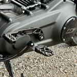 The TC Bros. Pro Series Truss Shift Lever for 2018-Up Harley-Davidson M8 Softail features silver and black metal lever arms with geometric cut-outs and "TC Bros." engraving—ideal for your Softail upgrade.