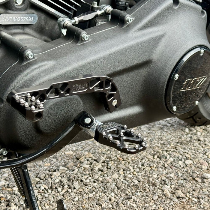 The TC Bros. Pro Series Truss Shift Lever for 2018-Up Harley-Davidson M8 Softail features silver and black metal lever arms with geometric cut-outs and "TC Bros." engraving—ideal for your Softail upgrade.