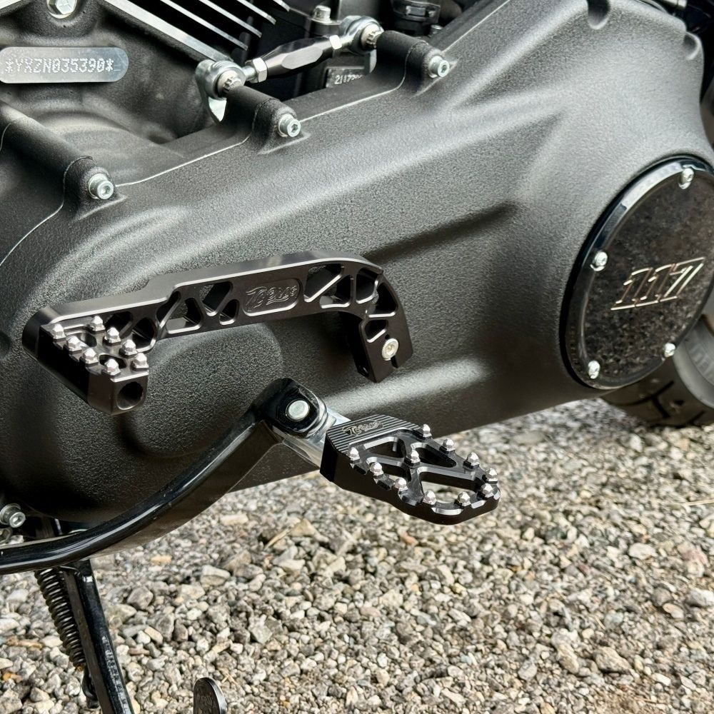 The TC Bros. Pro Series Truss Shift Lever for 2018-Up Harley-Davidson M8 Softail features silver and black metal lever arms with geometric cut-outs and "TC Bros." engraving—ideal for your Softail upgrade.