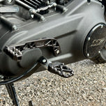 The TC Bros. Pro Series Truss Shift Lever for 2018-Up Harley-Davidson M8 Softail features silver and black metal lever arms with geometric cut-outs and "TC Bros." engraving—ideal for your Softail upgrade.