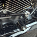 Two metal brackets, one silver and one black, each with a matching screw and bolt, displayed on a white background. Text reads "TC Bros. Pro Series Easy Shift Lever Extension for Harley-Davidson Big Twin—Milwaukee-Eight.
