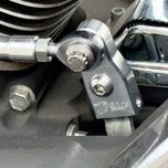 The TC Bros. Pro Series Easy Shift Lever Extension for Harley-Davidson Big Twin—Twin Cam includes silver and black metal brackets with threaded holes, engraved logos, and screws. Fits Touring, Dyna, and Softail models.