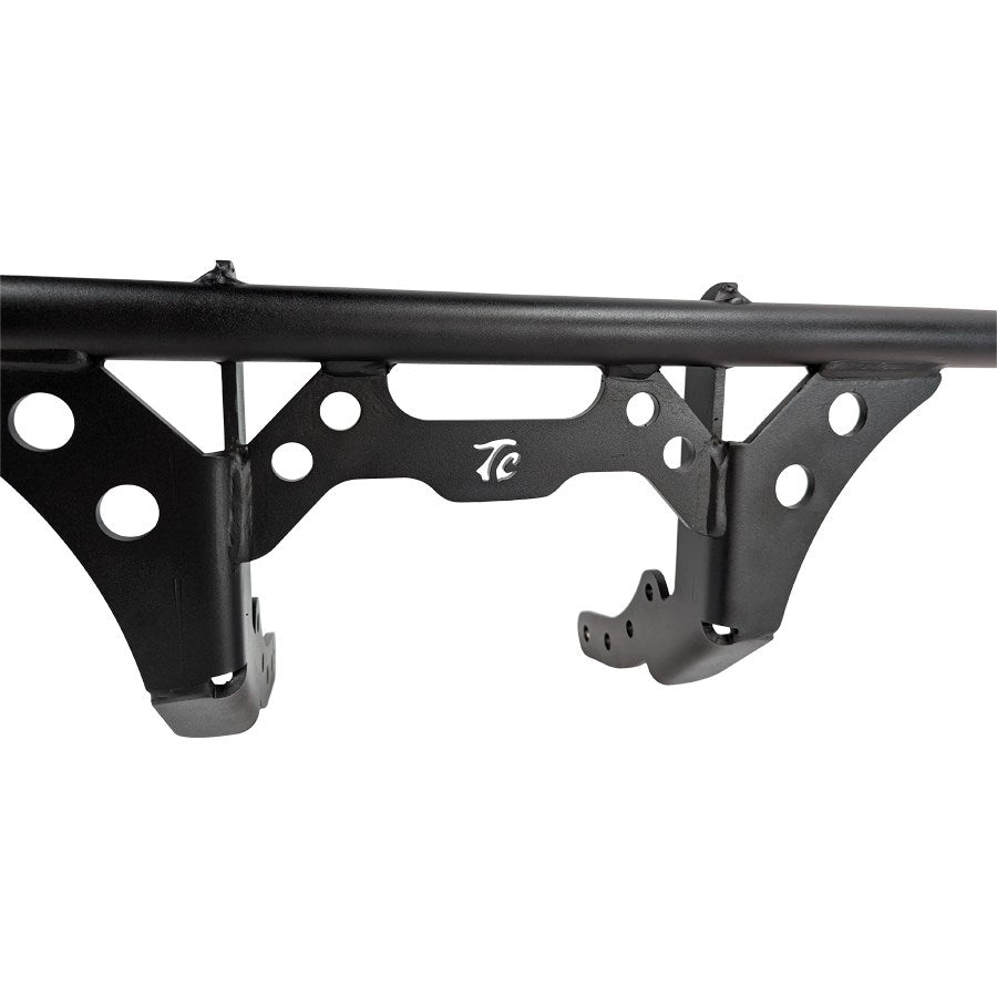 A black TC Bros. M8 Softail Front Crash Bar fits 2018+ FXST, FXBB, FXBBS, FXLR, FXLRS, FXLRST bumper bracket with holes on it.