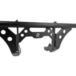 The TC Bros. Front Crash Bar for Harley-Davidson M-8 Softail w/ Mid Controls is a black metal engine guard, shown with mounting hardware—bolts, washers, spacers, and brackets—ideal for added protection on your Softail.