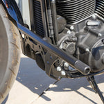The TC Bros. Front Crash Bar for Harley-Davidson M-8 Softail w/ Mid Controls is a black metal engine guard, shown with mounting hardware—bolts, washers, spacers, and brackets—ideal for added protection on your Softail.