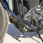 The TC Bros. Front Crash Bar for Harley-Davidson M-8 Softail w/ Mid Controls is a black metal engine guard, shown with mounting hardware—bolts, washers, spacers, and brackets—ideal for added protection on your Softail.