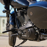 The TC Bros. Front Crash Bar for Harley-Davidson M-8 Softail w/ Mid Controls is a black metal engine guard, shown with mounting hardware—bolts, washers, spacers, and brackets—ideal for added protection on your Softail.