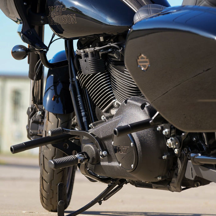 A black TC Bros. motorcycle is parked on a street.