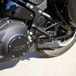The TC Bros. Rear Crash Bar for Harley-Davidson M8 Softail includes black metal brackets, bolts, washers, nuts, spacers, and CNC-machined Delrin® sliders from TC Bros., all arranged on a white background.