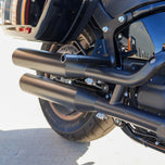 The TC Bros. Rear Crash Bar for Harley-Davidson M8 Softail includes black metal brackets, bolts, washers, nuts, spacers, and CNC-machined Delrin® sliders from TC Bros., all arranged on a white background.