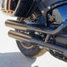 The TC Bros. Rear Crash Bar for Harley-Davidson M8 Softail includes black metal brackets, bolts, washers, nuts, spacers, and CNC-machined Delrin® sliders from TC Bros., all arranged on a white background.