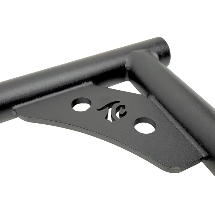 Two black metal TC Bros. Rear Saddlebag Guards with mounting holes, four bolts, two nuts, and four rubber grommets are arranged on a white background—essential components from TC Bros. for installing rear saddlebag guards on 2009-up Harley-Davidson Touring models to enhance rear crash protection.