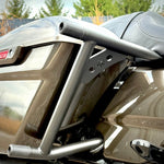 Two black metal TC Bros. Rear Saddlebag Guards with mounting holes, four bolts, two nuts, and four rubber grommets are arranged on a white background—essential components from TC Bros. for installing rear saddlebag guards on 2009-up Harley-Davidson Touring models to enhance rear crash protection.