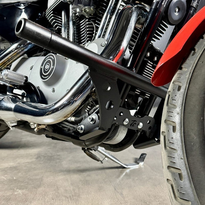 The TC Bros. Front Crash Bar for 2004-2022 Harley-Davidson Sportster features black metal arms and a horizontal bar with multiple mounting holes, offering added crash protection. Shown on a white background. Brand: TC Bros.