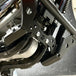 The TC Bros. Front Crash Bar for 2004-2022 Harley-Davidson Sportster features black metal arms and a horizontal bar with multiple mounting holes, offering added crash protection. Shown on a white background. Brand: TC Bros.