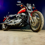 The TC Bros. Front Crash Bar for 2004-2022 Harley-Davidson Sportster features black metal arms and a horizontal bar with multiple mounting holes, offering added crash protection. Shown on a white background. Brand: TC Bros.