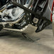 The TC Bros. Front Crash Bar for 2004-2022 Harley-Davidson Sportster features black metal arms and a horizontal bar with multiple mounting holes, offering added crash protection. Shown on a white background. Brand: TC Bros.