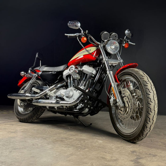 TC Bros. Upper Shock Mount Crash Sliders for 2000-2022 Harley-Davidson Sportster shown with two black sliders, two silver bolts, washers, and spacers on a white background—perfect for added crash protection.