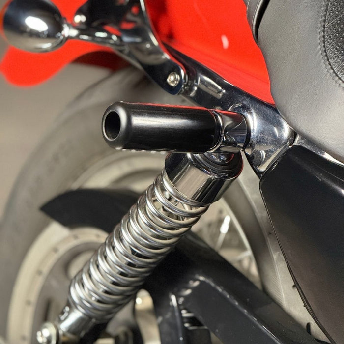 TC Bros. Upper Shock Mount Crash Sliders for 2000-2022 Harley-Davidson Sportster shown with two black sliders, two silver bolts, washers, and spacers on a white background—perfect for added crash protection.
