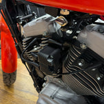 An image of a TC Bros. Coil Relocation Bracket for a 2004-2006 Harley Sportster motorcycle ignition coil.