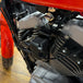 An image of a TC Bros. Coil Relocation Bracket for a 2004-2006 Harley Sportster motorcycle ignition coil.