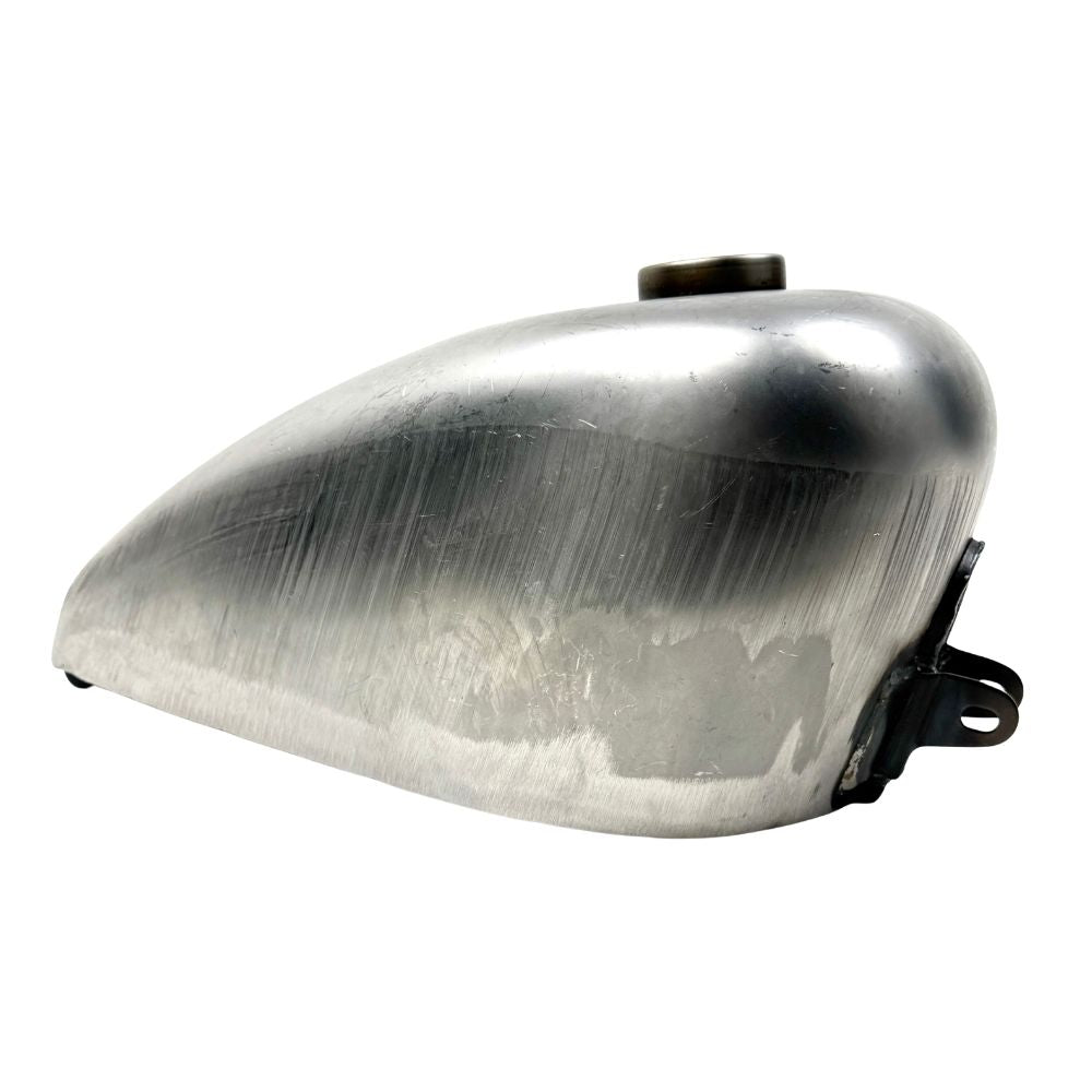 The Wyatt Gatling 2 Gallon Gas Tank features unpainted metal with visible weld marks and a top-mounted fuel cap, designed for 1958-1978 Harley-Davidson Sportster models.