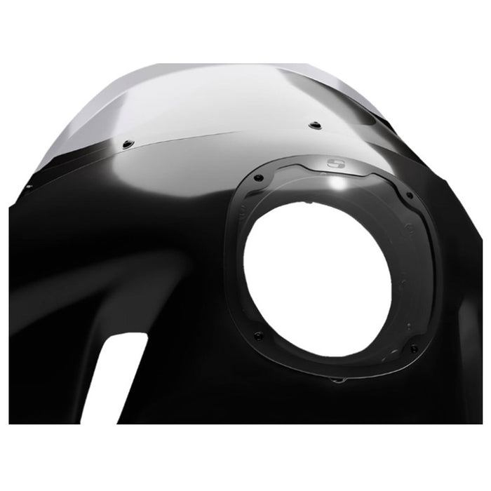 A Saddlemen Mini Fairing in black, specifically for 1996-2005 Dyna Models, featuring a large circular cutout for headlight fitting and a small rectangular side vent designed to enhance wind protection.