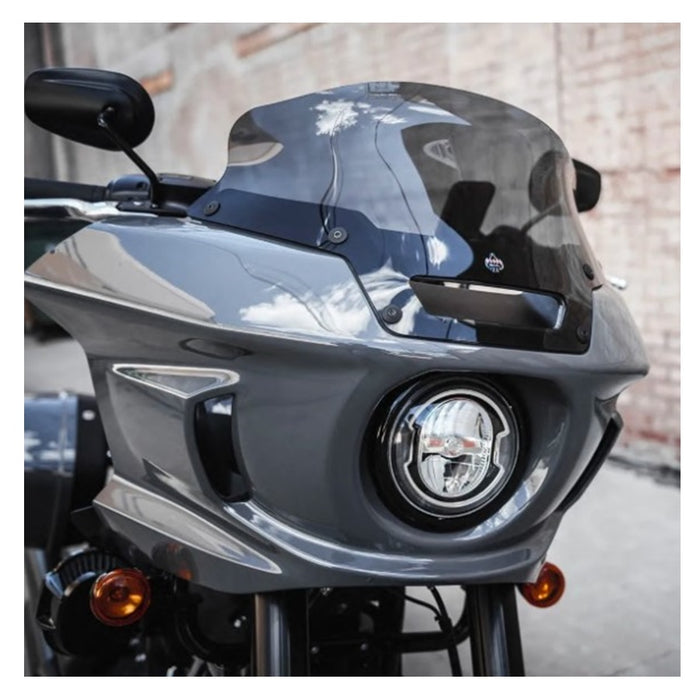 Gray Klockwerks Flare windshield - 6" - Dark Smoke - For 2022-2024 Softail Low Rider ST FXLRST with a logo in the center.