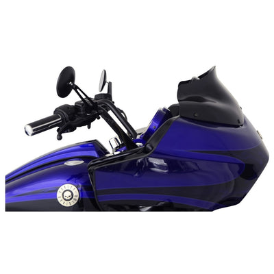 Close-up view of a blue motorcycle with a skull emblem on the front fairing, featuring twin headlights and black handlebars, equipped with a Klockwerks Flare Windshield - 8" - Black - For 1998-2013 FLTR.