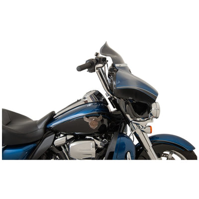 A blue touring motorcycle with saddlebags and a Klockwerks Flare Windshield - 8-1/2" - Dark - Smoke - For '14-'24 FLHT, isolated on a white background.