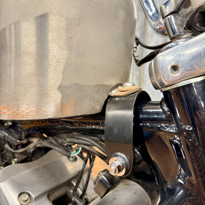 The TC Bros. Frisco Gas Tank Adapter Brackets set for 1982-2003 Harley-Davidson Sportster includes black metal brackets, bolts, washers, nuts, and rubber grommets—perfect for tongue-mount fuel tank installations.