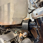 The TC Bros. Frisco Gas Tank Adapter Brackets set for 1982-2003 Harley-Davidson Sportster includes black metal brackets, bolts, washers, nuts, and rubber grommets—perfect for tongue-mount fuel tank installations.
