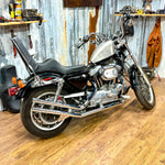 The TC Bros. Frisco Gas Tank Adapter Brackets set for 1982-2003 Harley-Davidson Sportster includes black metal brackets, bolts, washers, nuts, and rubber grommets—perfect for tongue-mount fuel tank installations.