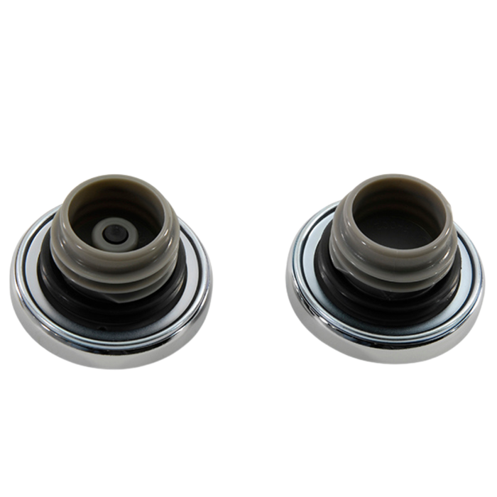 Two round, silver-colored sink stoppers with black rubber bases are shown on a white background, resembling a Wyatt Gatling Fuel Cap Set for L1996-Up Harley-Davidson with vented and non-vented caps by Wyatt Gatling.