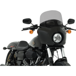 Two motorcycles display black front fairings, including a Road Warrior Fairing equipped with the Memphis Shades Windshield. Below them are three separate black Memphis Shades pieces, made from Lucite in different shapes and with various cutouts.