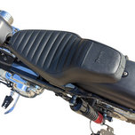 The TC Bros. Tracker Seat for Harley-Davidson Sportster 1986-2003 by TC Bros. is shown above a partially visible Sportster motorcycle.