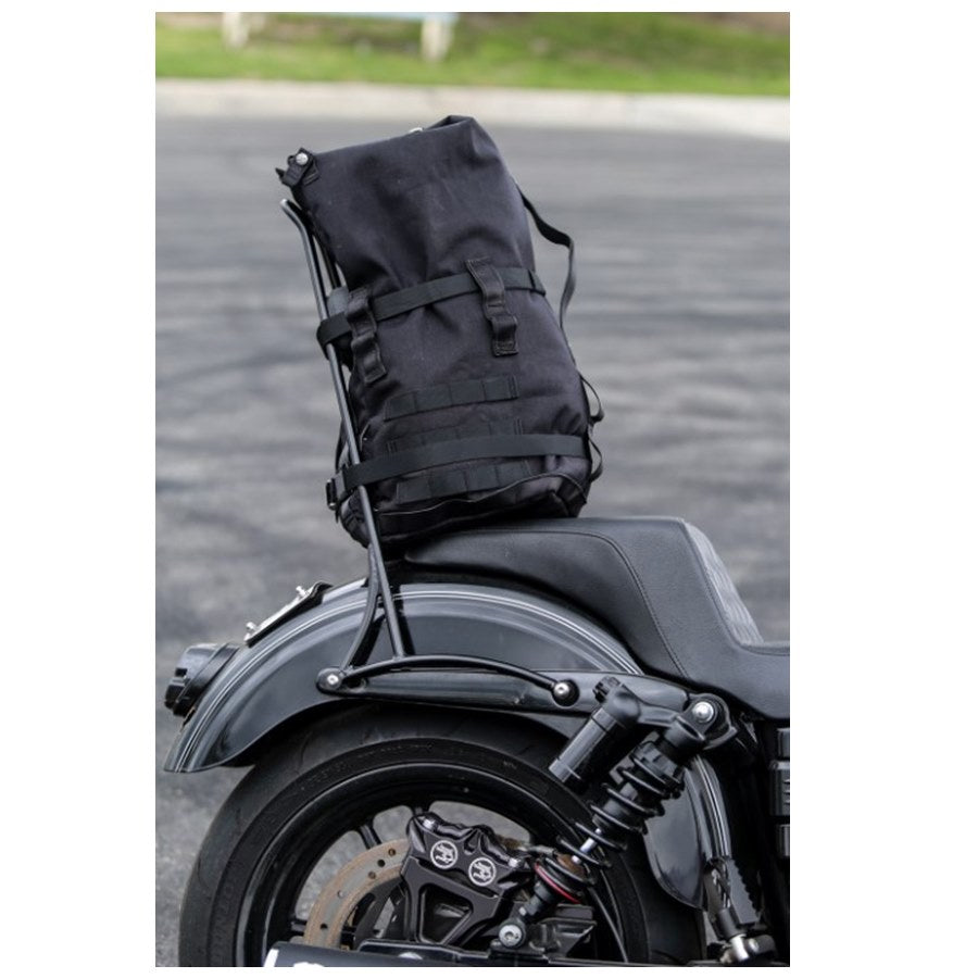 The Burly Voyager Motorcycle Sissy Bar Backpack by Burly is available in black and crafted from durable Black Cordura. It features multiple compartments, a buckled front pocket, and additional side handles. The backpack is also equipped with a MOLLE system for versatile attachment options.