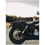 Introducing the Speedwell Cutaway Saddlebags for Harley Sportsters, M8 Softail, and Dyna—an elegant black saddlebag featuring dual compartments with stitched detailing and handles on each side. Expertly designed to straddle over the back of a motorcycle seat, it's the perfect accessory for your ride.