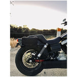 Introducing the Speedwell Cutaway Saddlebags for Harley Sportsters, M8 Softail, and Dyna—an elegant black saddlebag featuring dual compartments with stitched detailing and handles on each side. Expertly designed to straddle over the back of a motorcycle seat, it&
