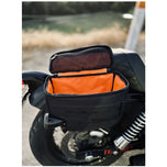 Introducing the Speedwell Cutaway Saddlebags for Harley Sportsters, M8 Softail, and Dyna—an elegant black saddlebag featuring dual compartments with stitched detailing and handles on each side. Expertly designed to straddle over the back of a motorcycle seat, it&