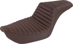 The Saddlemen Step-Up Seat for 1996-2003 Harley-Davidson Dyna is shown with other Saddlemen seats in black and brown, highlighting diverse designs and textures against a white background.